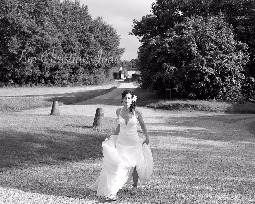 The bride in her wedding dress walking with no shoes on