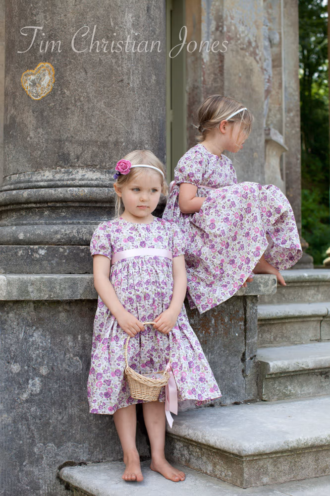 Flower girls on the stone steps and columns outside the Temple of Apollo in West Yorkshire
