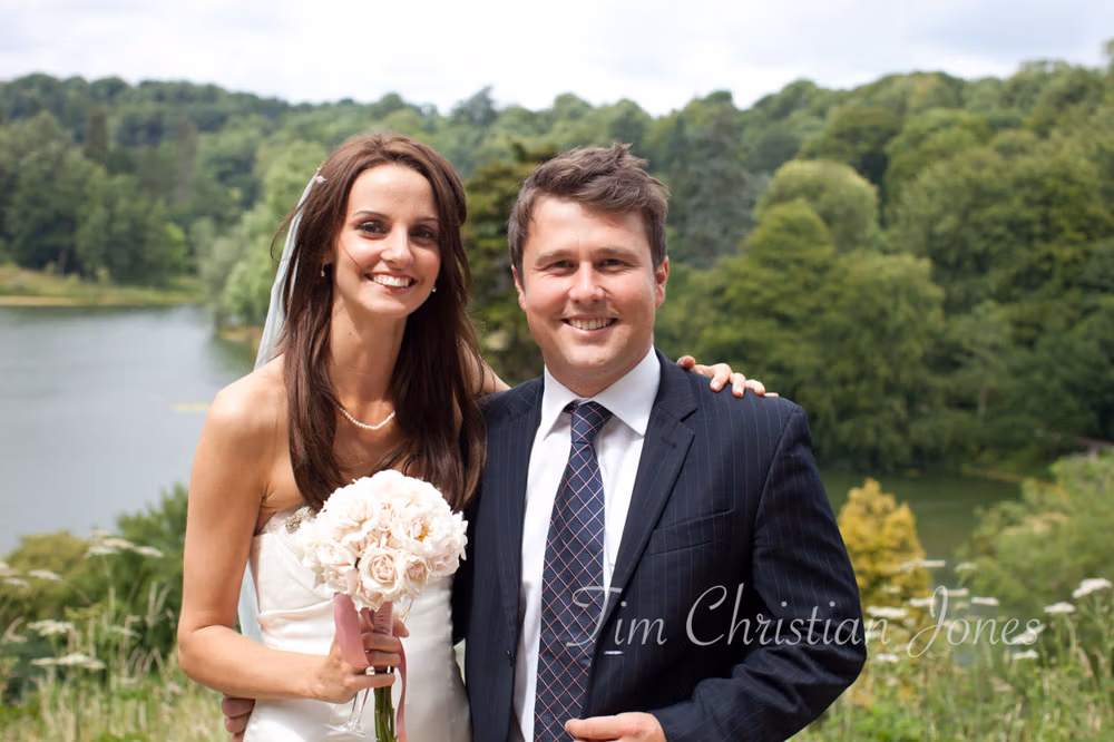 Bride and her brother share a photo outside before the reception