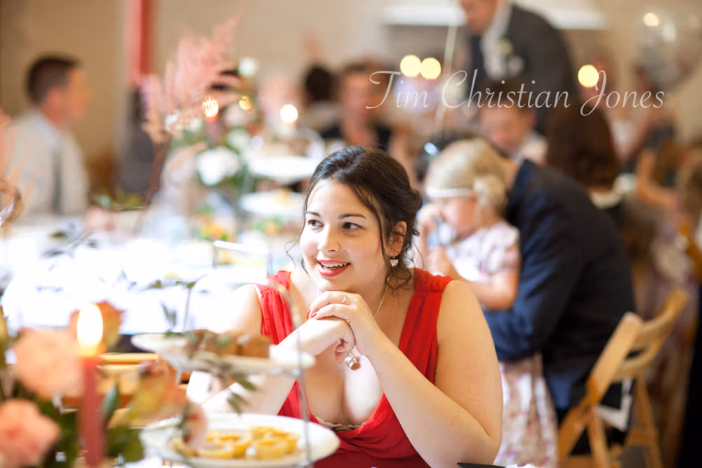 Best man and his girlfriend smiling together at the wedding reception