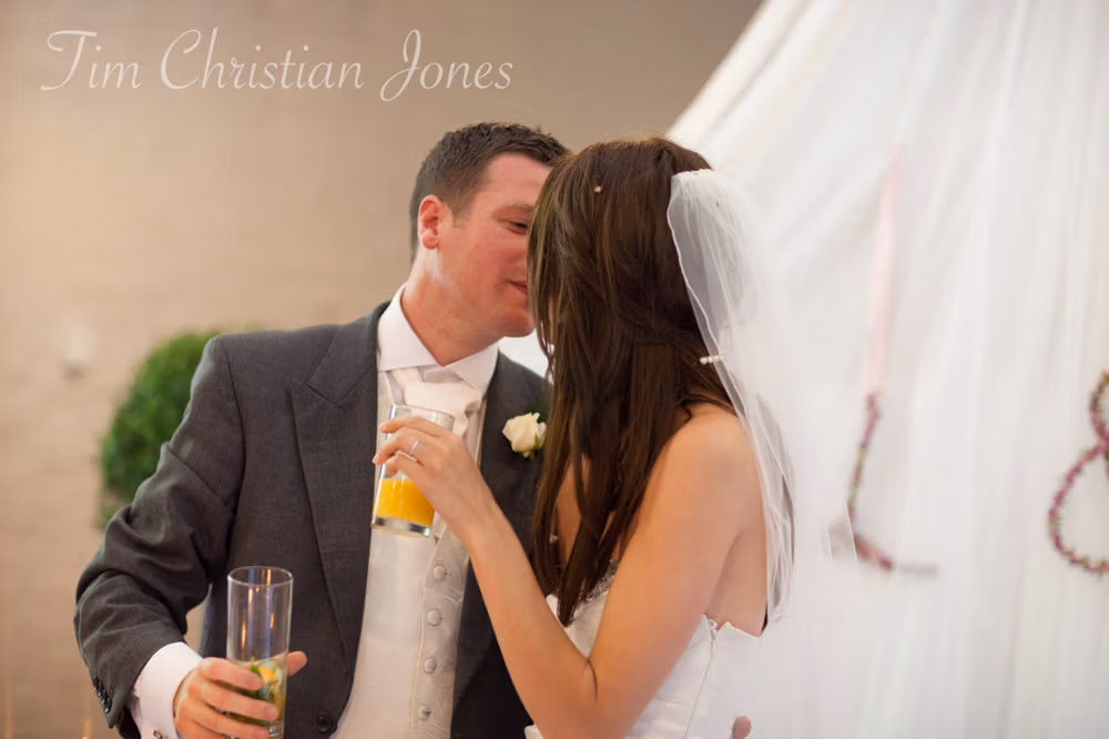 Best man raising a glass beside his girlfriend during the toast