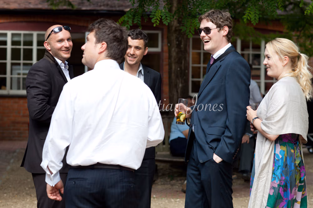 Father of the bride taking off his cravat to unwind after speeches