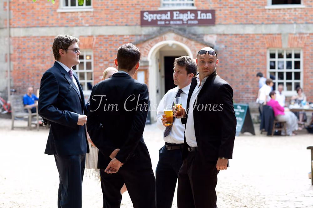 Wedding guests mingling in the warm evening light