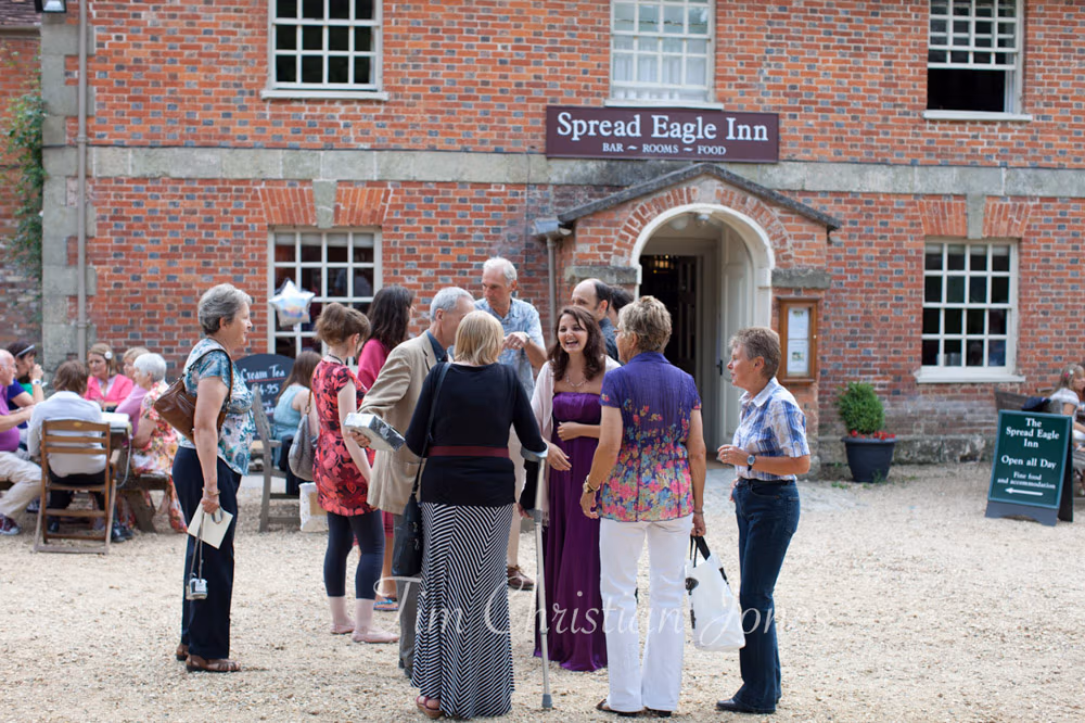 Guests gathered outside The Spread Eagle pub in evening light
