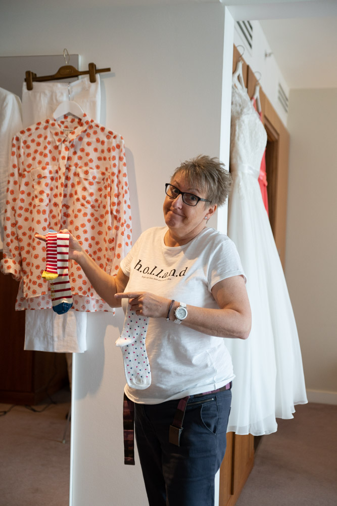Tracey deciding which colourful patterned socks to wear