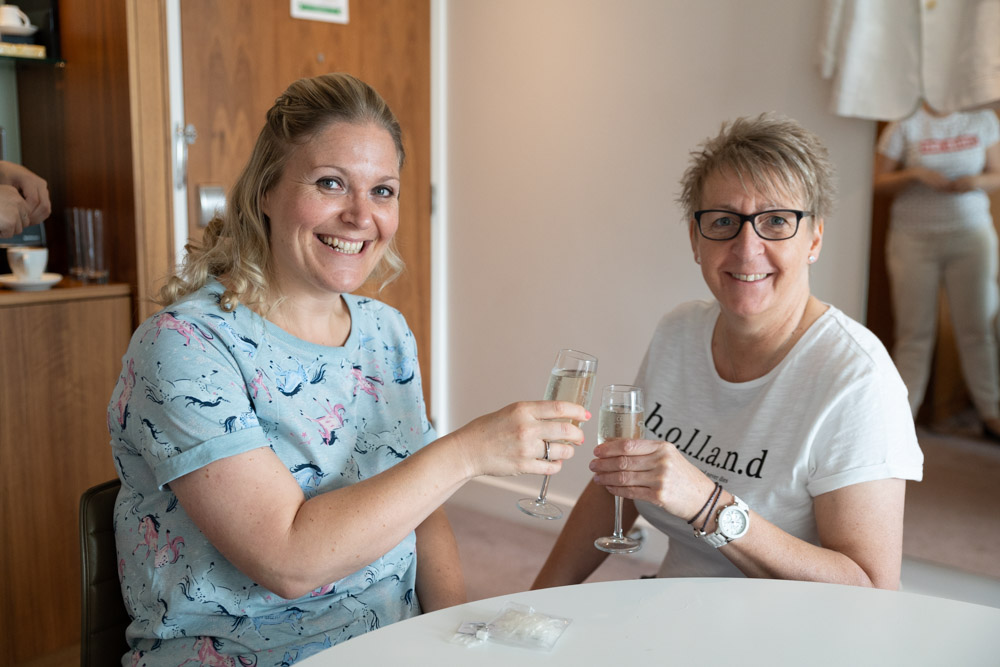 Clare and Tracey toasting champagne during their Leeds wedding morning