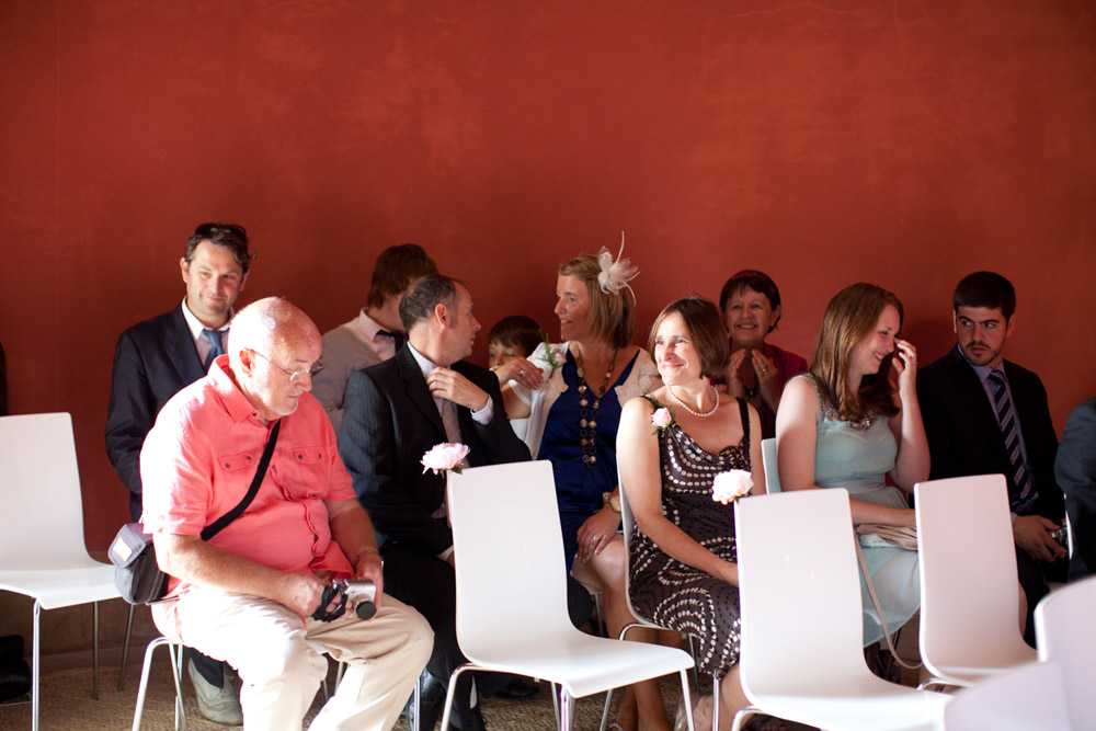Guests sat with the red walls behind