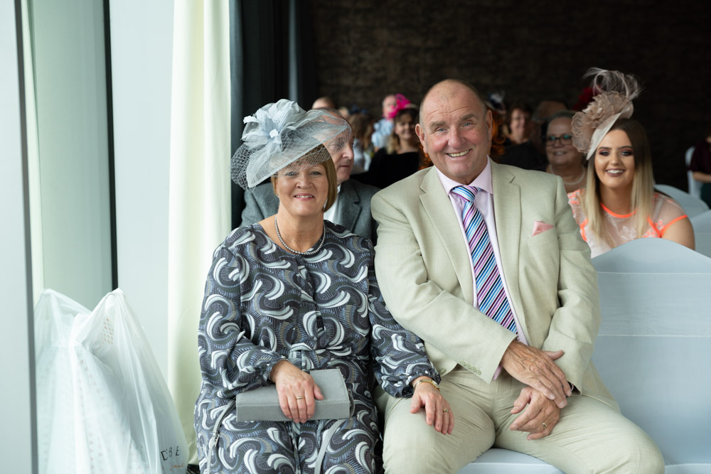 Wedding guests sharing smiles before the couple’s arrival