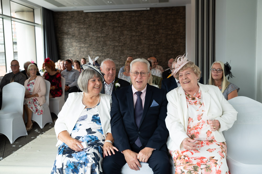 Grandparents sitting proudly in the front row before the ceremony