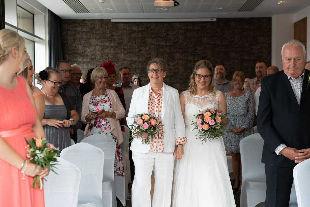 Clare and Tracey walking into their Leeds wedding ceremony
