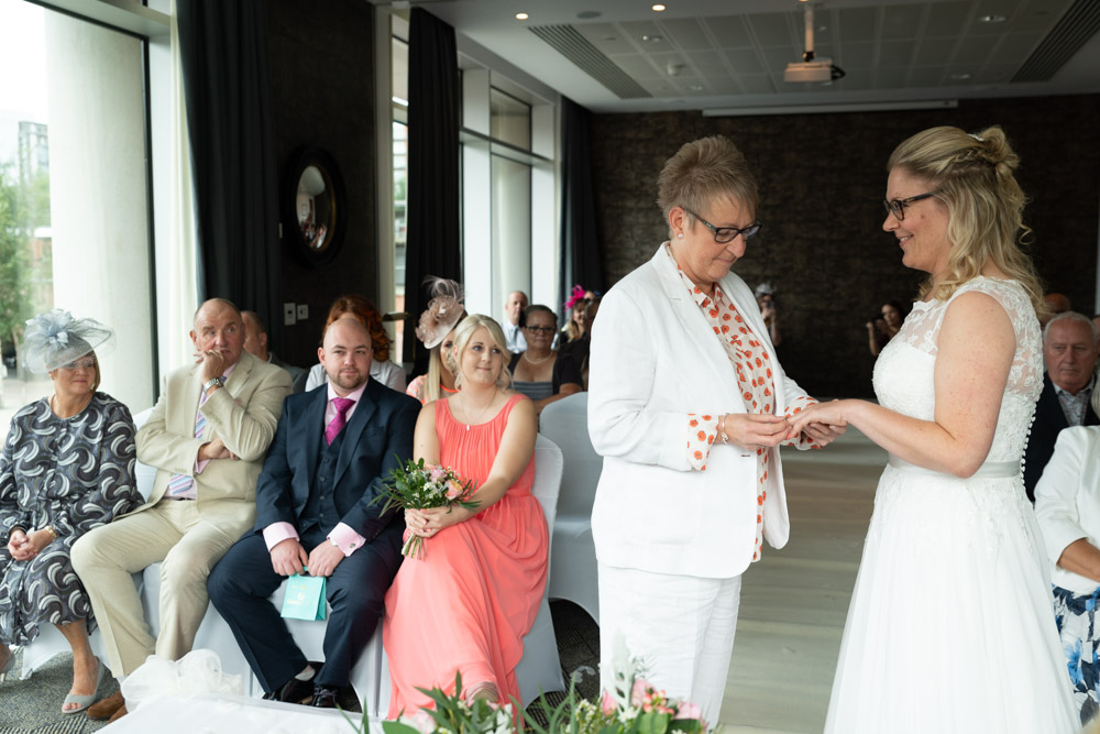 Clare and Tracey exchanging rings with steady hands