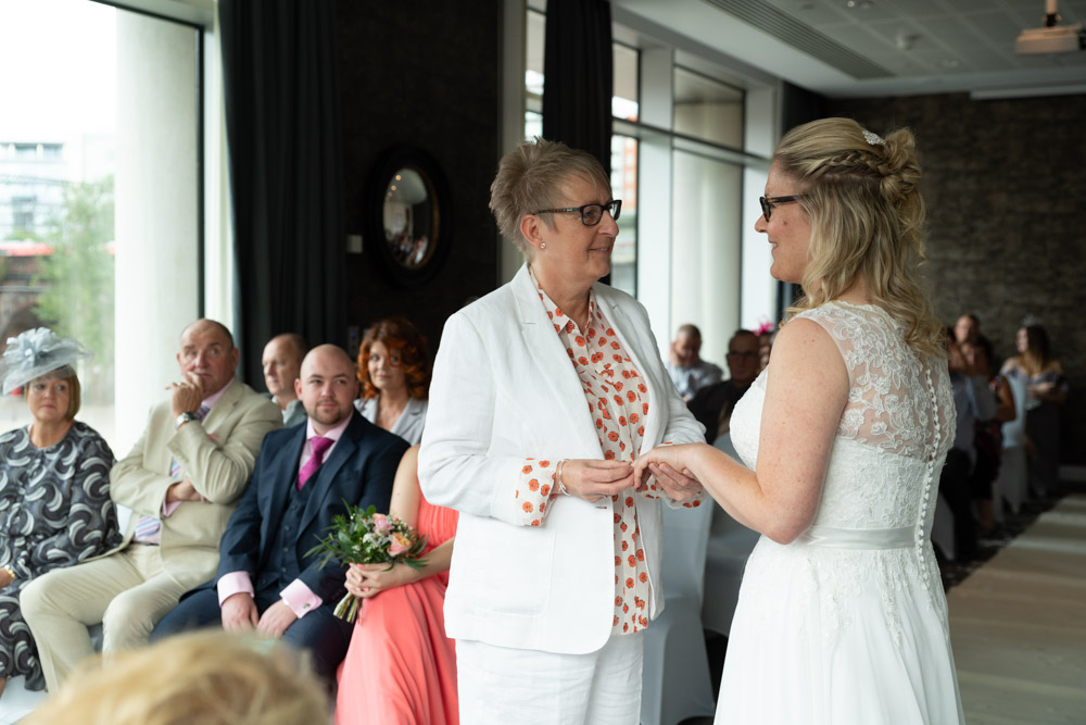 Tracey fits Clare’s ring on her finger