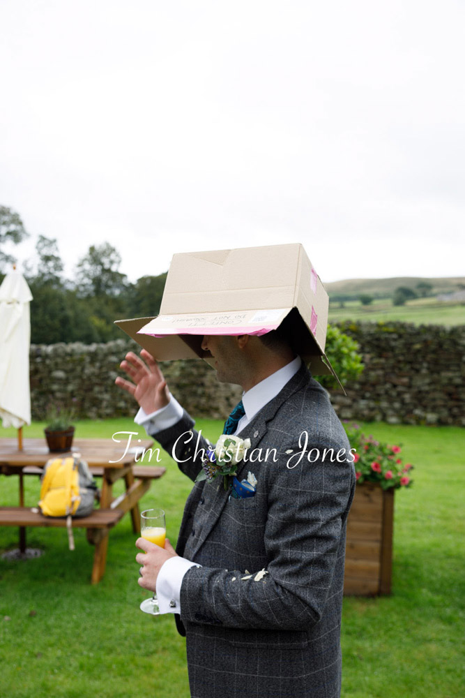 Yorkshire Wedding Romance at The Priest’s House – Jane & Callum 37 037 guest hiding from rain with box jc