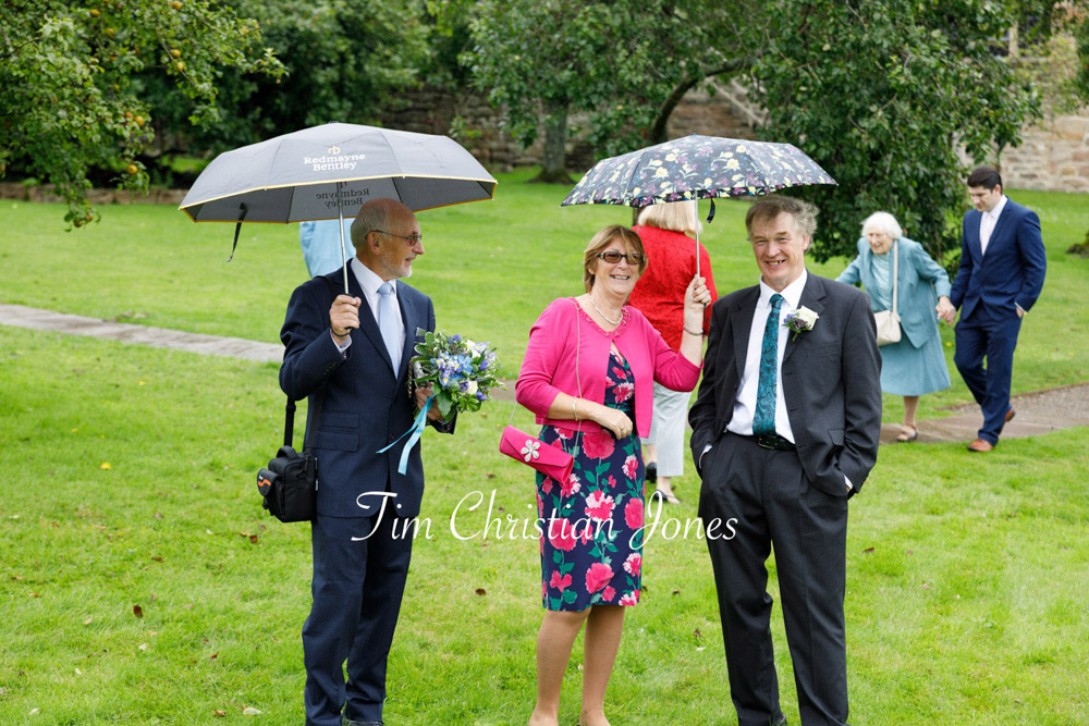 Yorkshire Wedding Romance at The Priest’s House – Jane & Callum 41 041 wedding guests with umbrellas barden tower jc