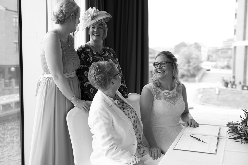 Black and white photo of the couple and witnesses smiling
