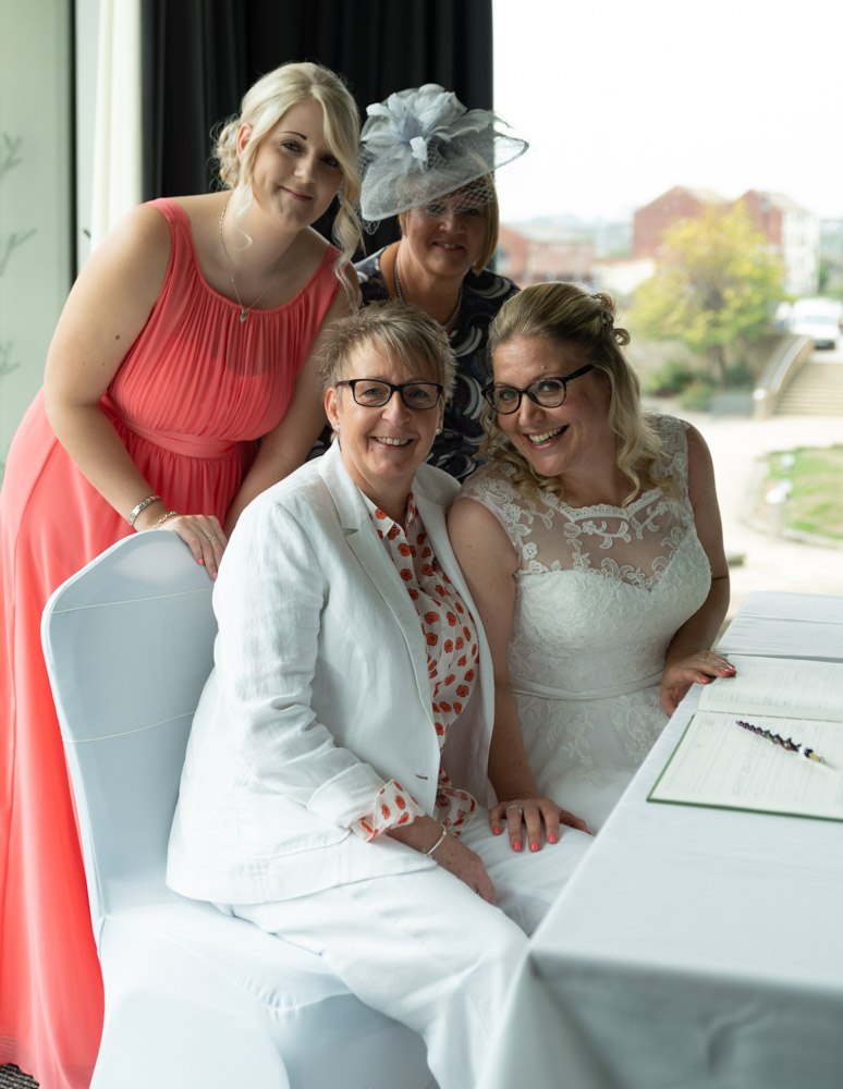 The couple and their witnesses huddle together for a sweet photo