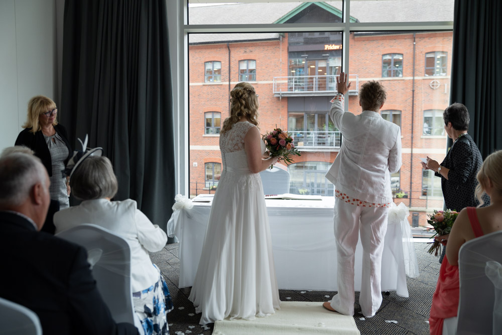 Tracey waving through the window at the onlookers outside