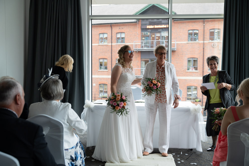 Clare and Tracey turn to face their wedding guests