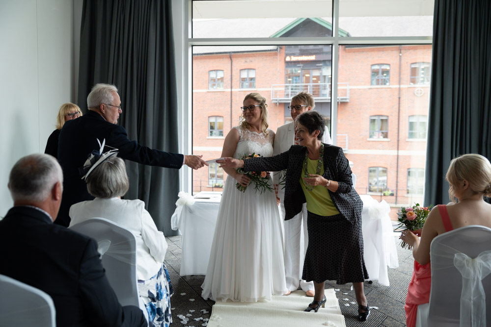 The marriage certificate being handed to a guest