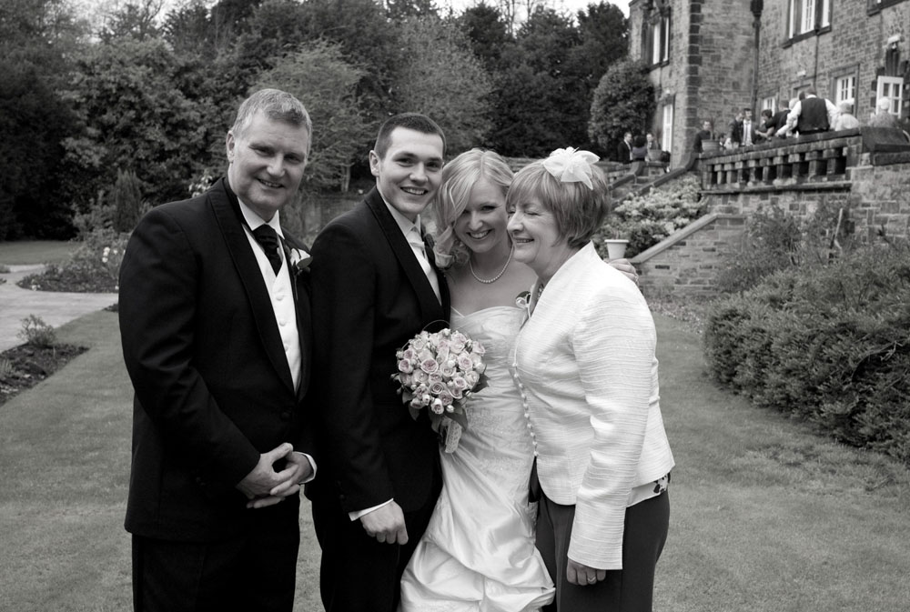 Dani and Scott in black and white with her parents at Hoyle Court