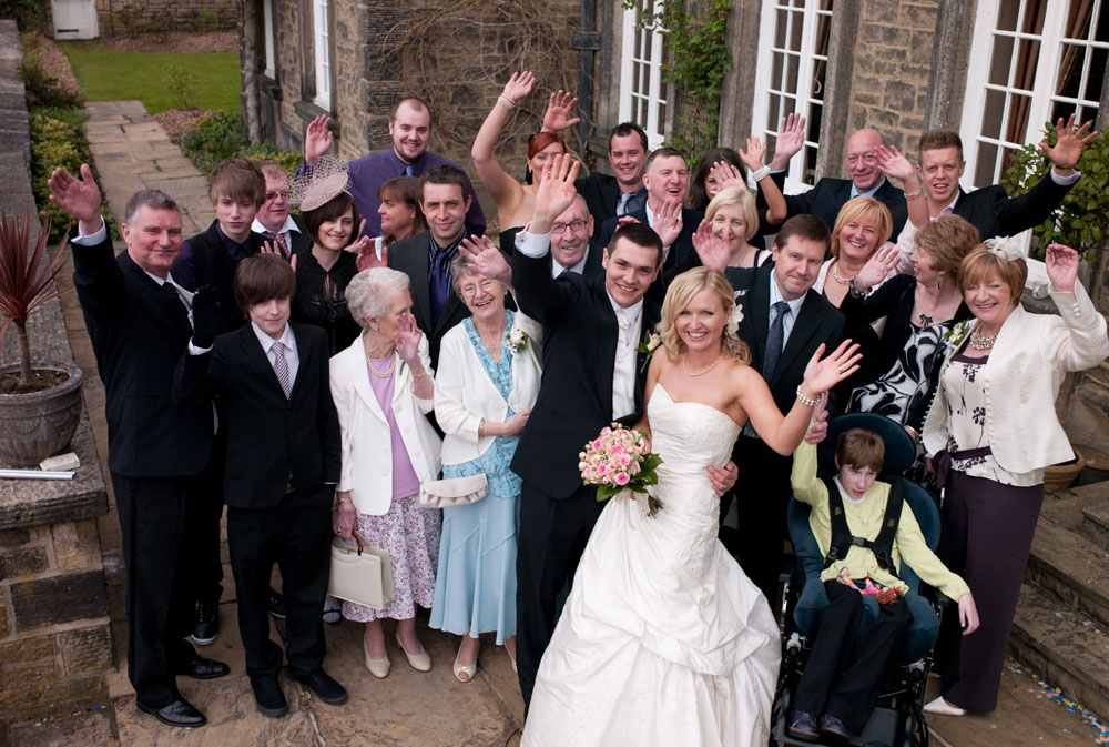 Photographer captures a family portrait from above, everyone looking up