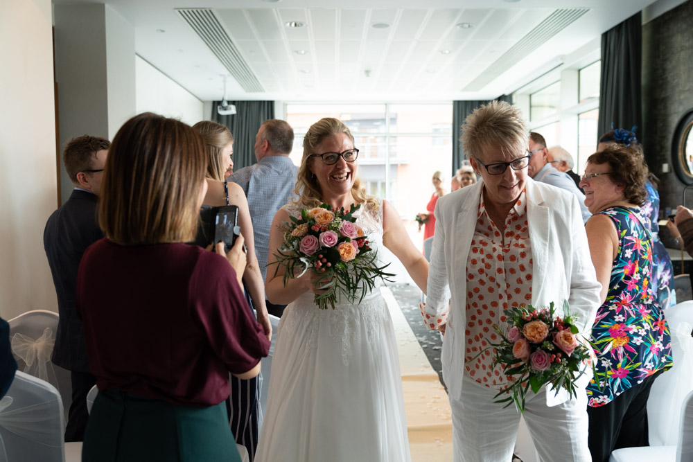 The couple reach the end of the aisle smiling