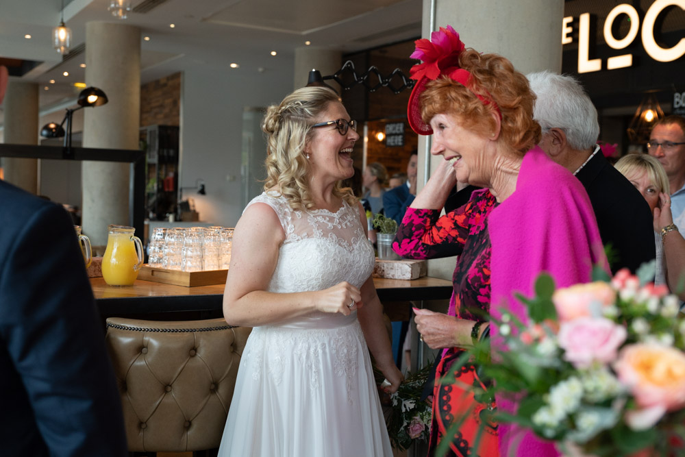 Guests beaming with happiness around the couple