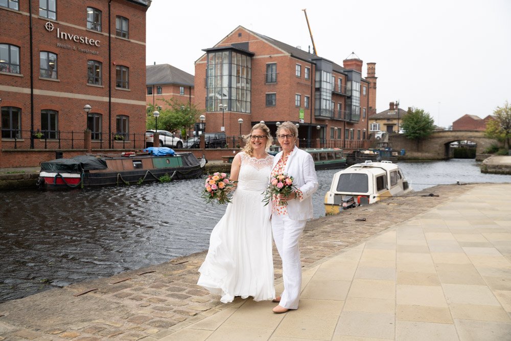 The couple standing close near the water