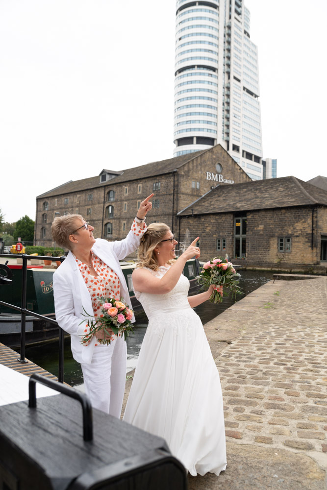 Clare and Tracey pointing playfully toward the sky