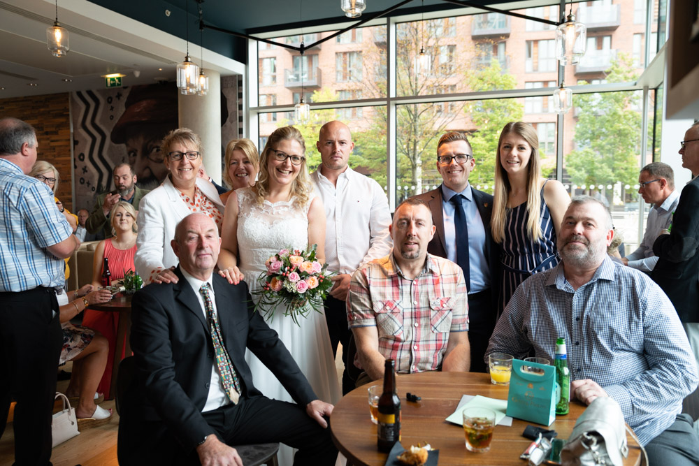 Group photo with friends and family, some seated and others standing