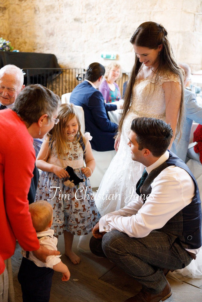 Yorkshire Wedding Romance at The Priest’s House – Jane & Callum 81 081 groom kneels to speak with bridesmaid jc