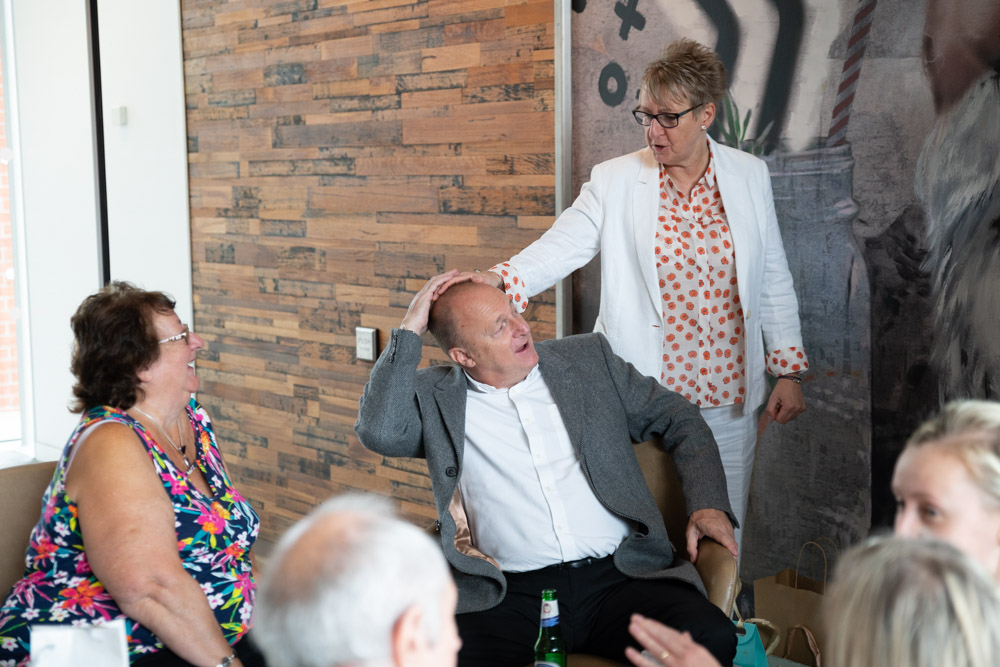 Tracey laughs with a friend mid-joke