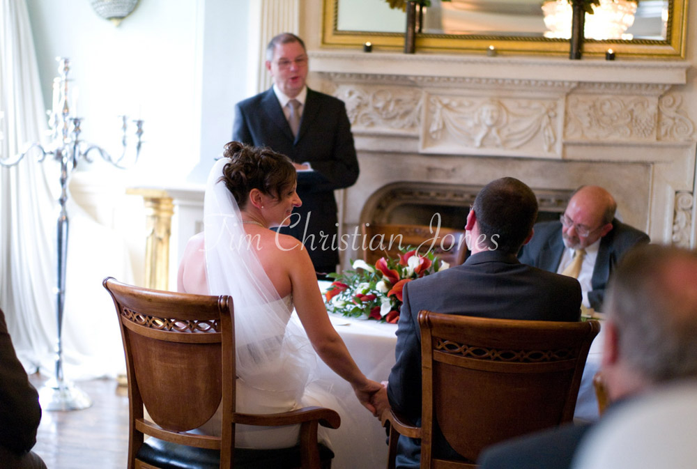Couple hand in hand during vows
