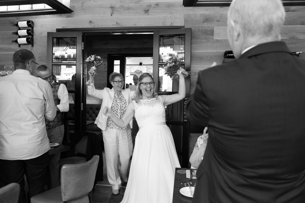 Black and white shot of the couple entering to applause