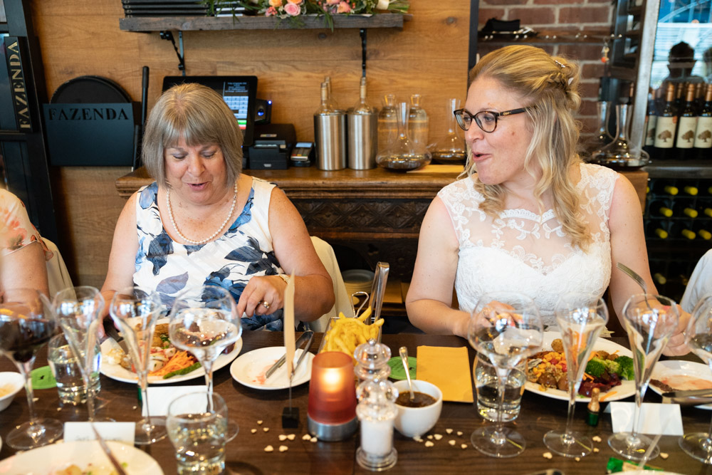Clare laughing while eating with her mum