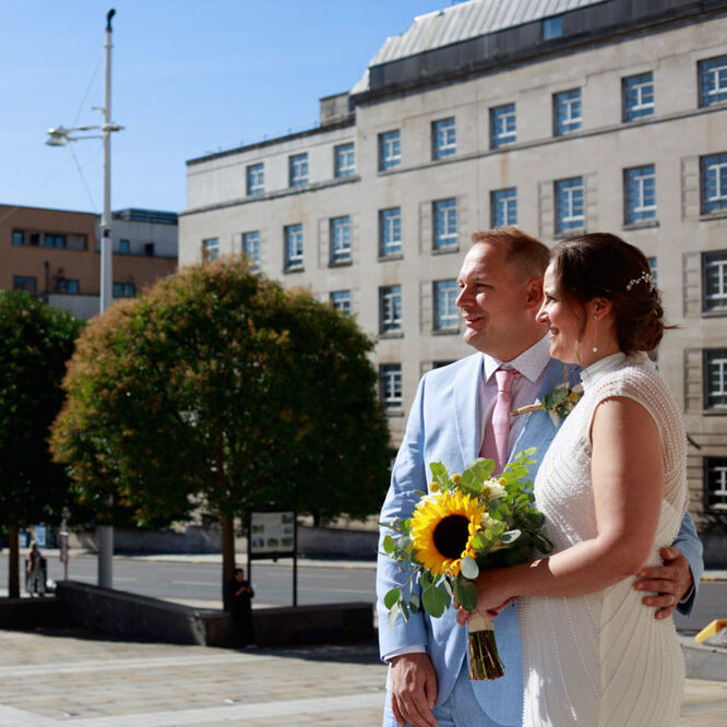 Wedding couple at Civic Hall Leeds overlooking the square and town hall in sunshine