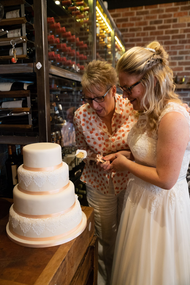 Clare and Tracey cut the first piece of their wedding cake