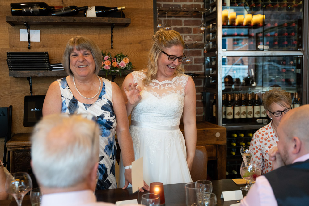The couple and guests smiling as the speeches conclude