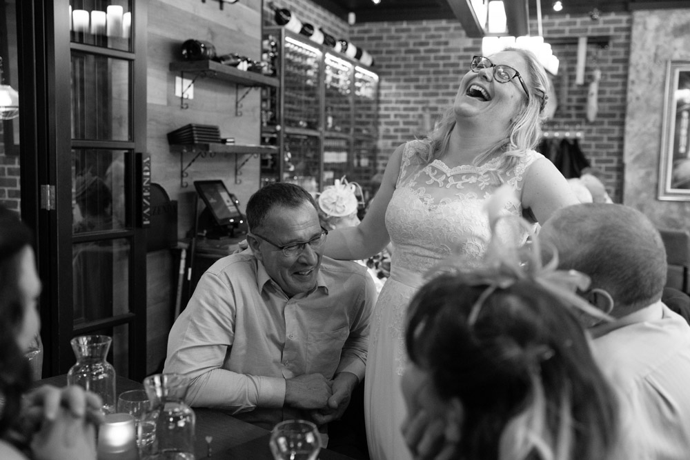 Clare laughing while chatting with guests at the tables