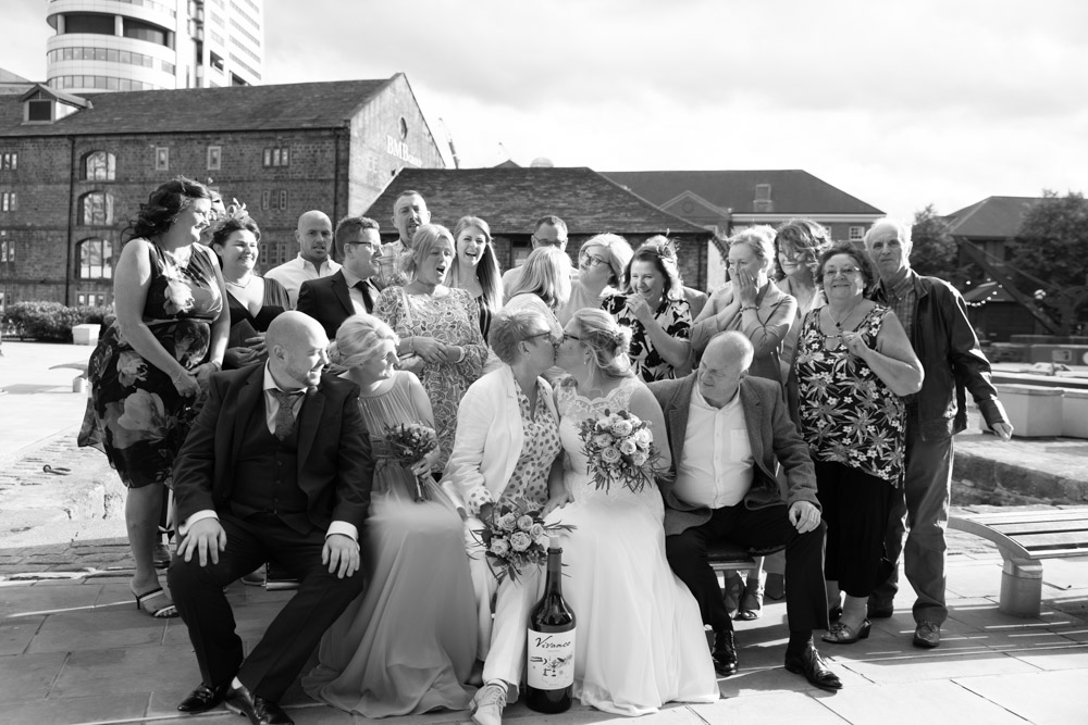 The couple kiss in front of the group as everyone reacts