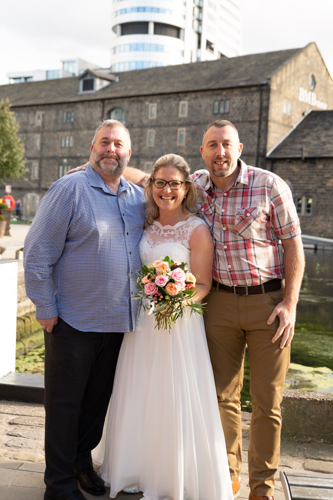 Clare smiling with her two brothers