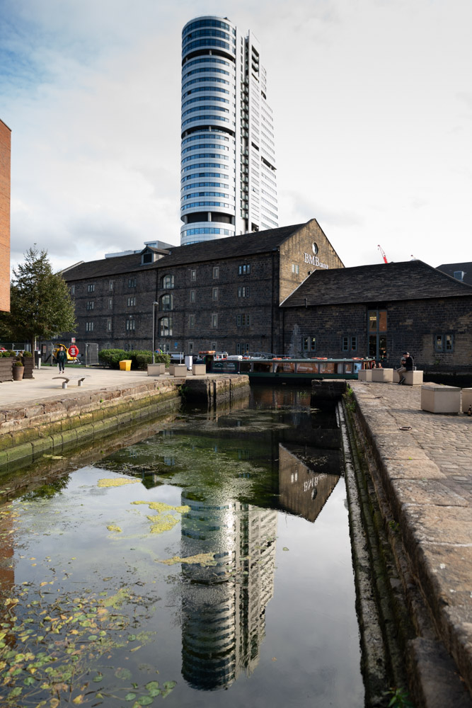A tall building reflected beautifully in the water