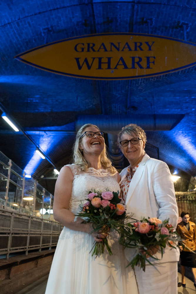 Close-up of the couple smiling beneath the blue glow