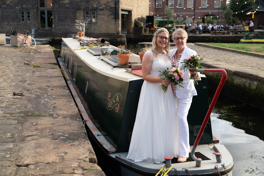 The couple stand on the front of a kind stranger’s canal boat