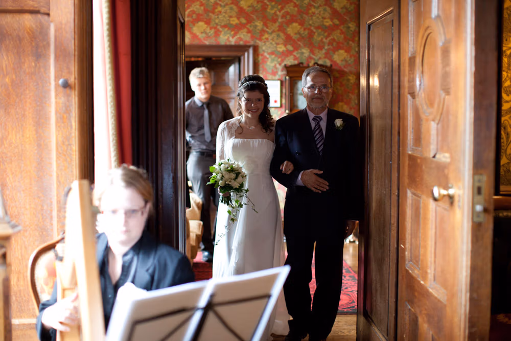 Bride and father walking with smiles as they near the ceremony space