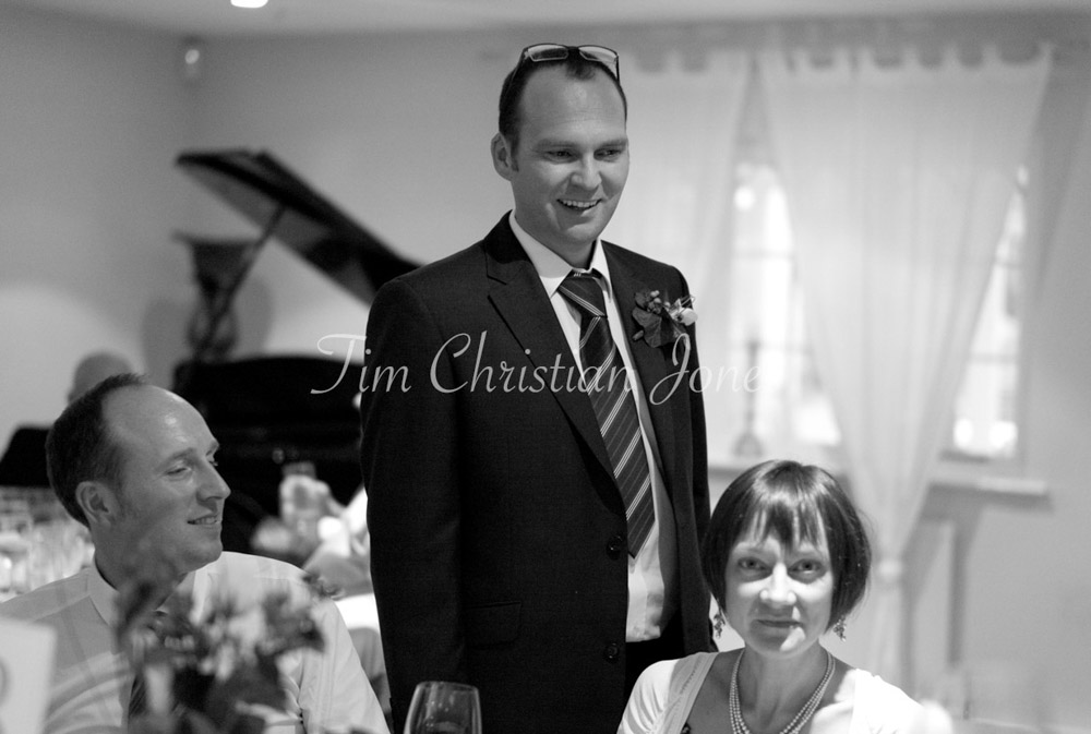 The groom says hi at the tables