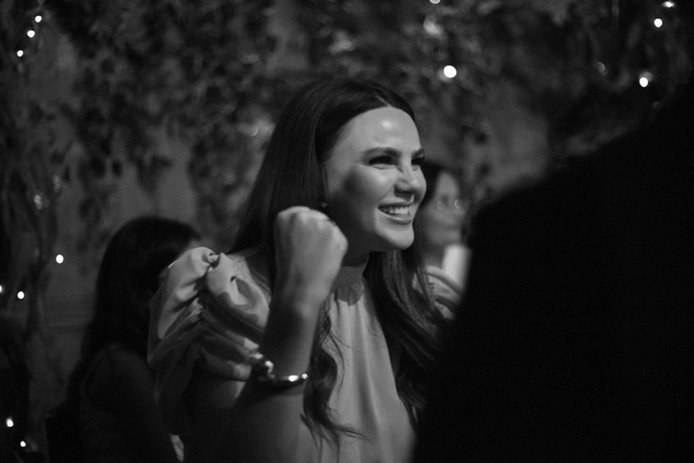 Female guest cheers with a playful fist pump