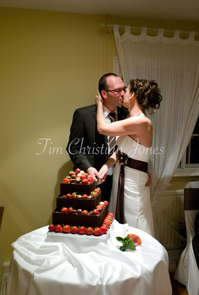 Cutting the cake with a knife and a kiss