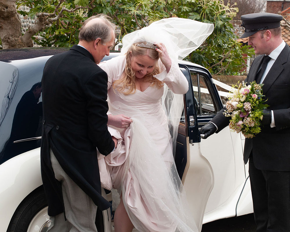 Leeds Wedding Photographer | Candid, Warm & Wonderfully Real 3 Bride's evil blowing in the wind but she has a lovely smile