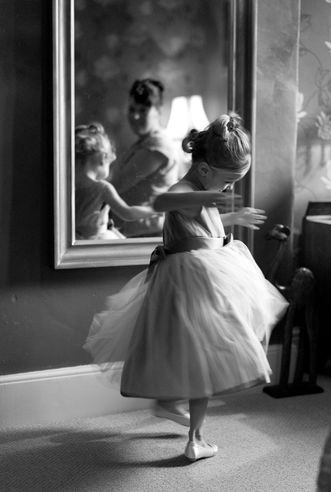Leeds Wedding Photographer | Candid, Warm & Wonderfully Real 10 Little bridesmaid twirling in her dress at Yorkshire wedding.